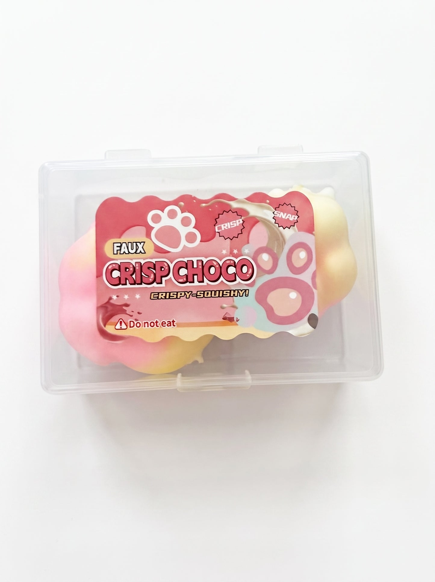 Le Sage May faux chocolate paw-shaped squishy toy in a clear plastic storage case for sensory stress relief.