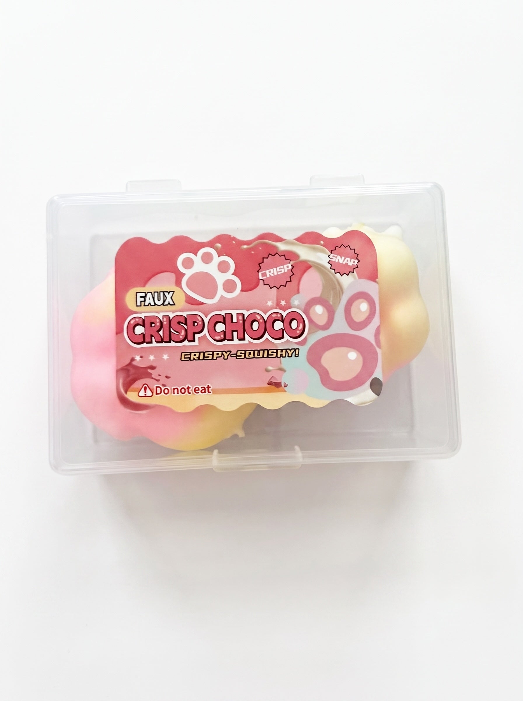 Le Sage May faux chocolate paw-shaped squishy toy in a clear plastic storage case for sensory stress relief.